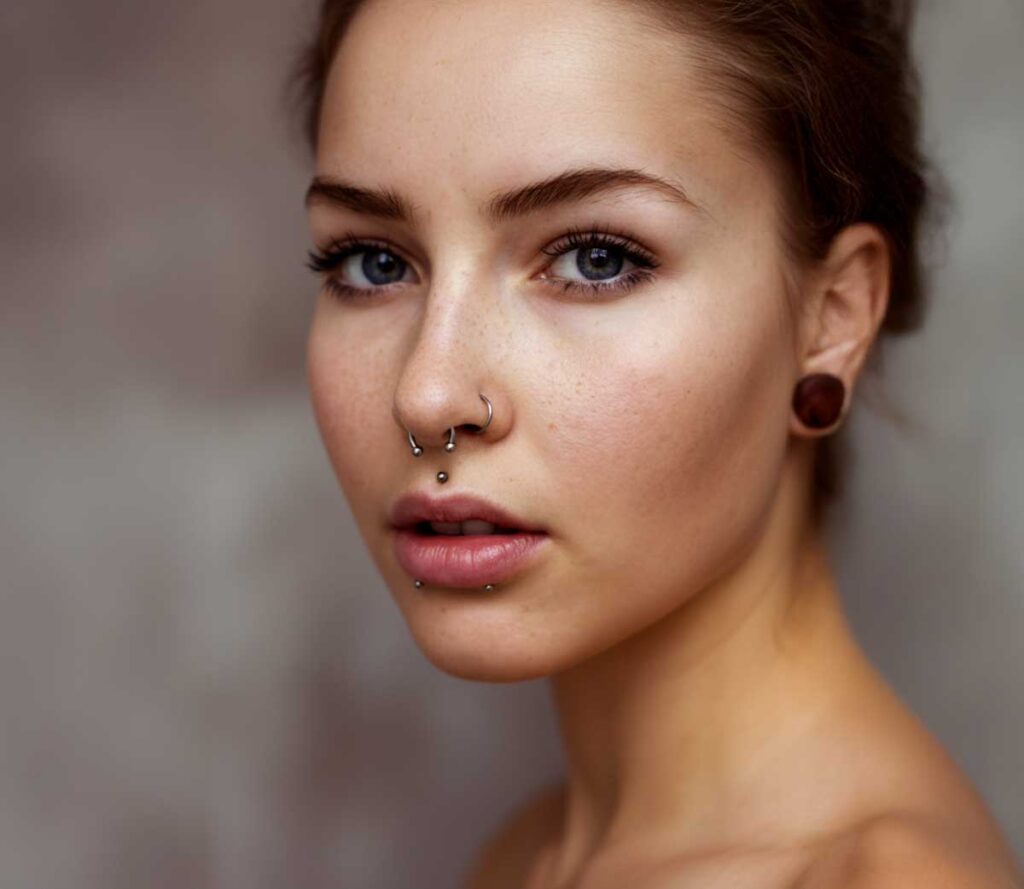 A person with facial and ear piercings.