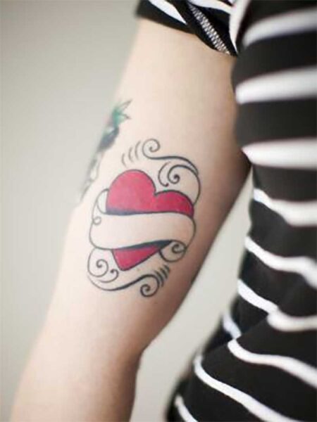 Heart shaped tattoo on woman's arm - Tetra Images - Jessica Peterson/Brand X Pictures/Getty Images