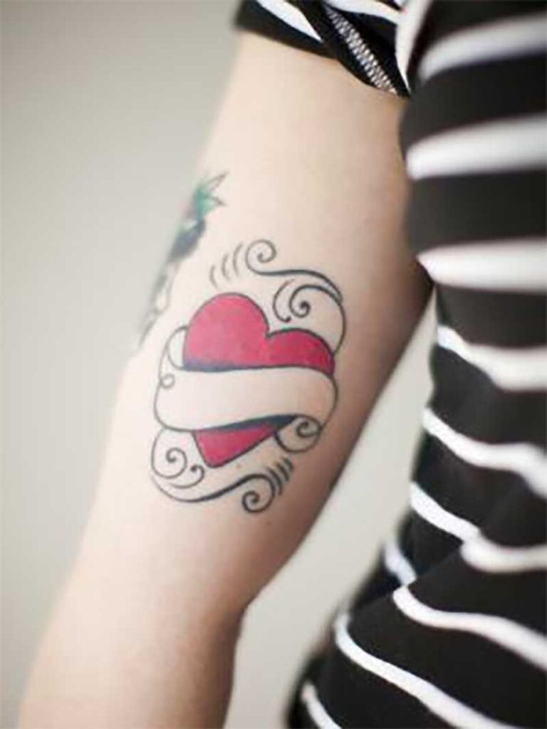 Heart shaped tattoo on woman's arm - Tetra Images - Jessica Peterson/Brand X Pictures/Getty Images