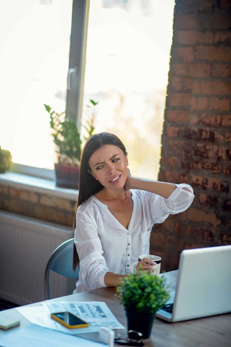 unhappy young woman feeling pain in the neck