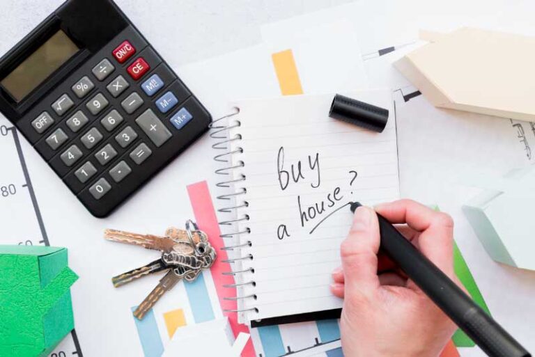 a person writing to buy a house on notepad