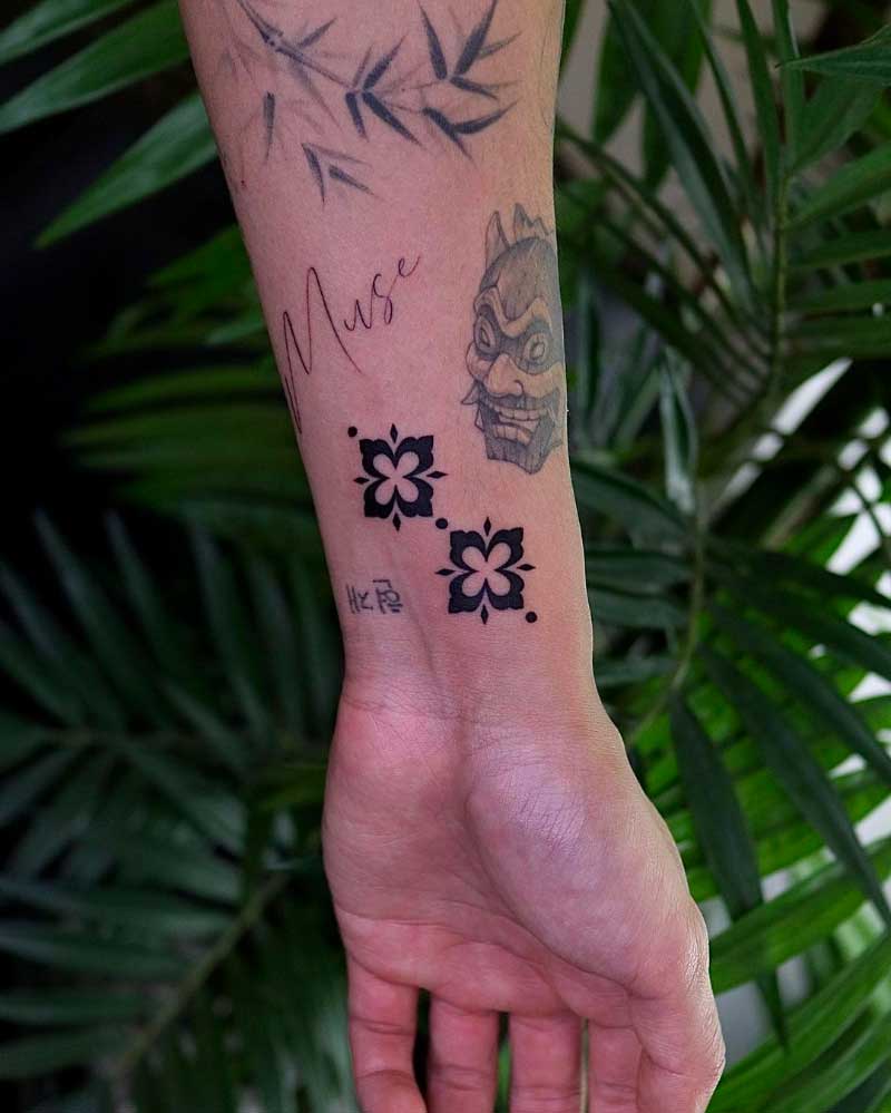 Woman with courage and compassion tattooed on wrists.