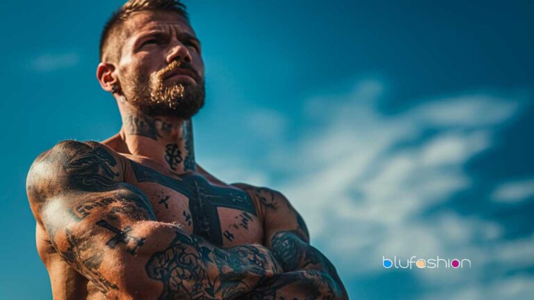 Muscular man with faith-inspired tattoos and prominent cross on shoulder.