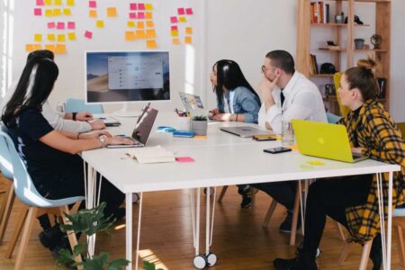 A team in an office discussing TEM during a meeting