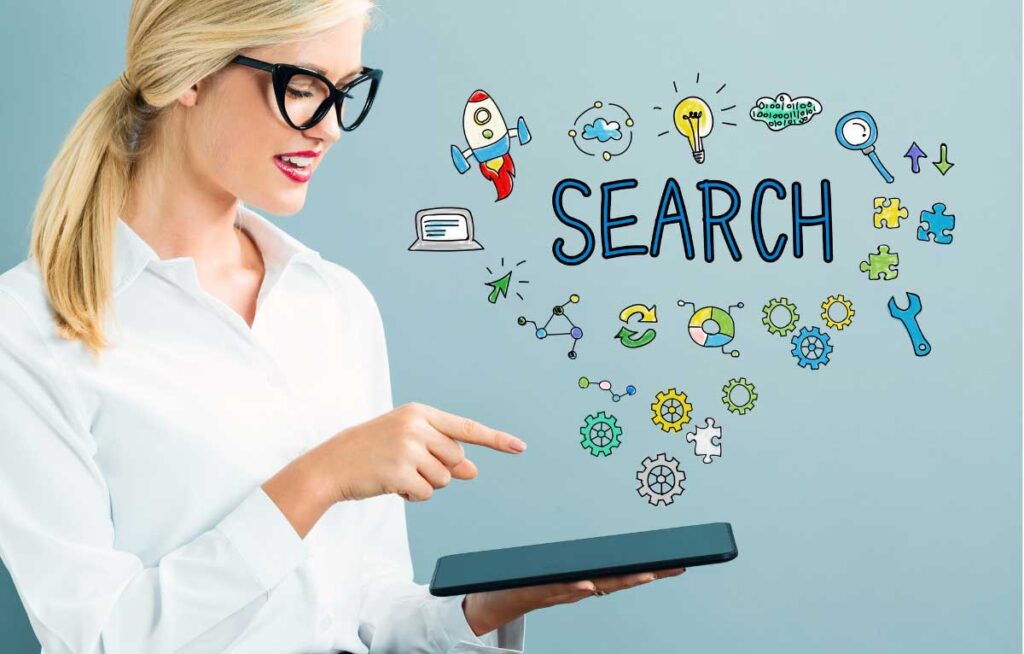 Businesswoman using tablet with creative search concept doodles overhead.