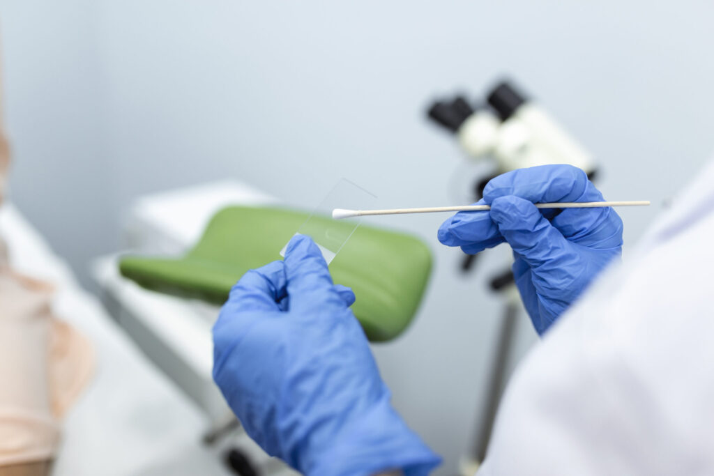 Vaginal Smear. Close-up of doctor hand holds gynecological examination instruments. Gynecologist working in the obstetrics and gynecology clinic.