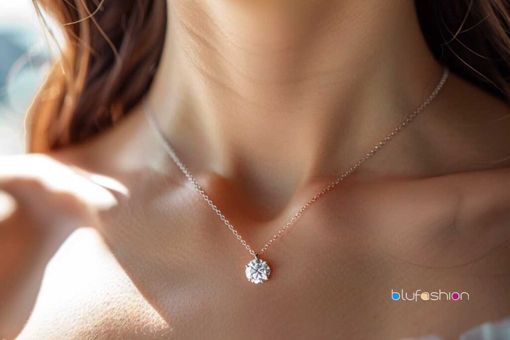 Celebrity Diamond Solitaire Necklace: Elegant woman wearing a delicate diamond solitaire necklace on a thin chain.