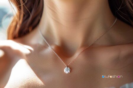 Celebrity Diamond Solitaire Necklace: Elegant woman wearing a delicate diamond solitaire necklace on a thin chain.